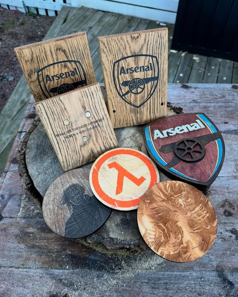 A laser-cut frame with embedded magnets and interchangeable face plates, beside an Arsenal sign.