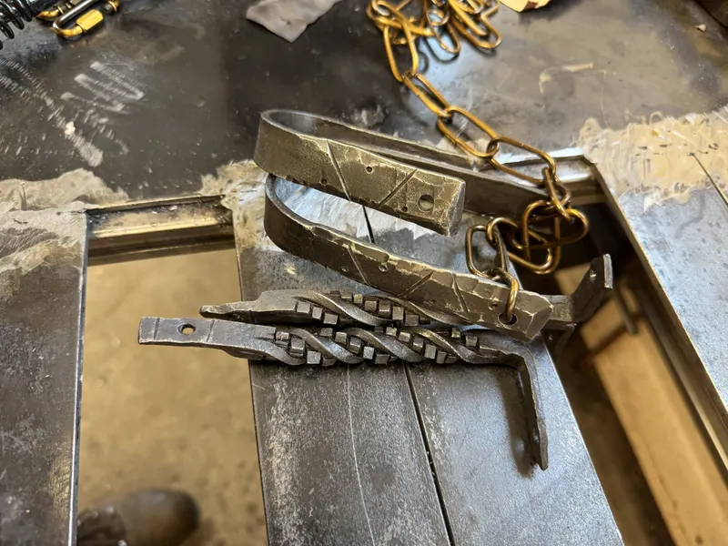 Assorted brackets for hanging a wooden branch light fixture.