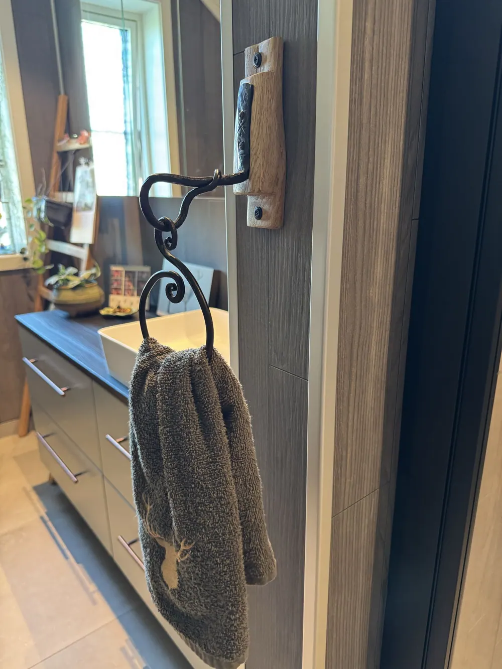 A towel rack made from steel and oak.